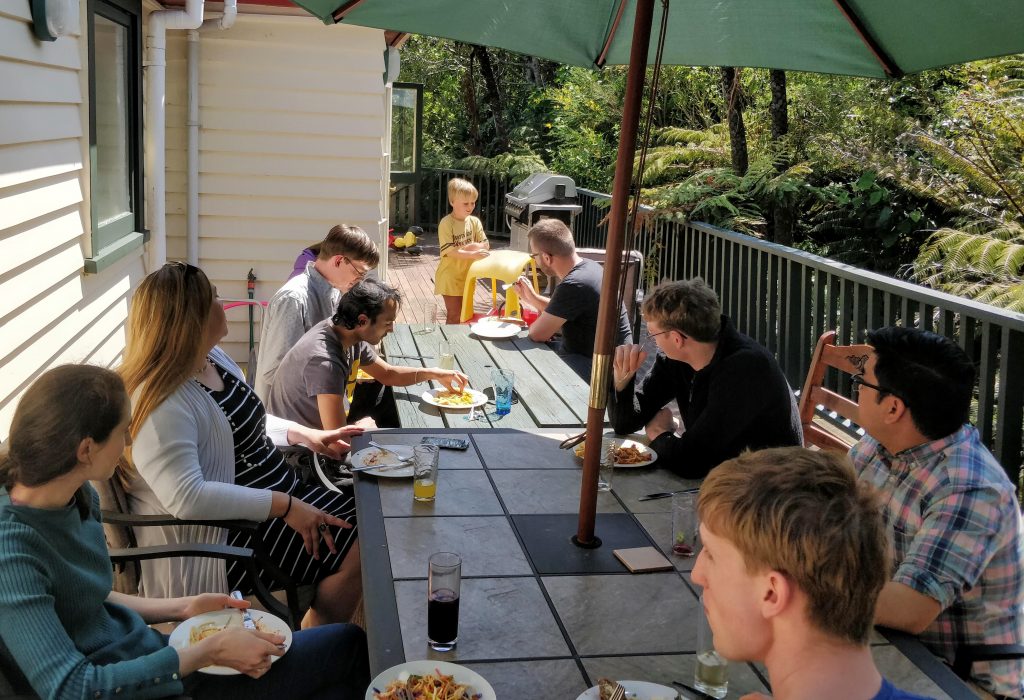 Sunday lunch - members and guests gathered outside under umbrella