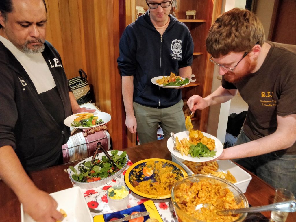 Sunday lunch - people gathered round the buffet table